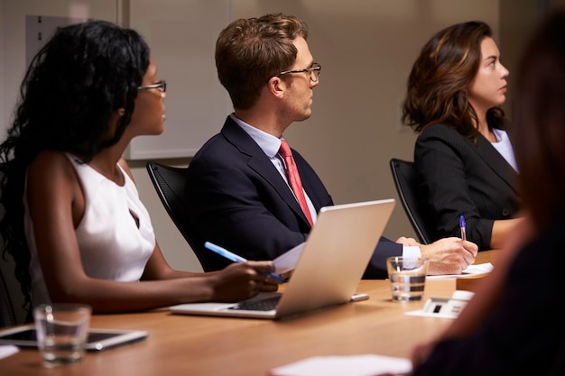 Singapore legal services team consulting with corporate clients in modern office setting